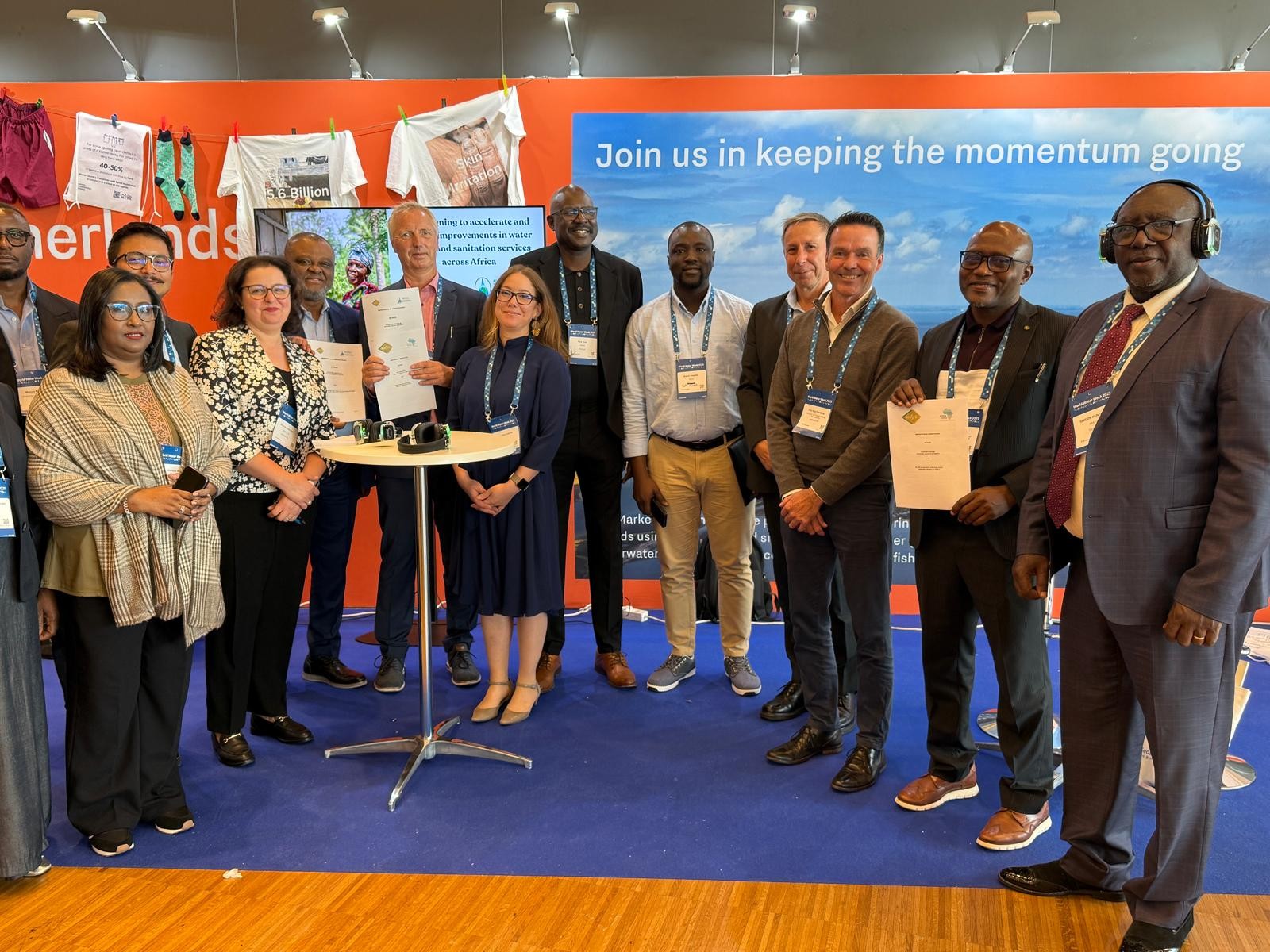 A group of representatives from WASTE, PASA and AfWASA standing togehter in a large group smiling