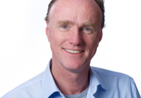 Frank smiling wearing a blue shirt