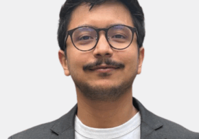 Sajib headshot in grey suit jacket and white t-shirt